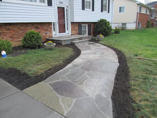 Stone walk and stoop and colored concrete driveway