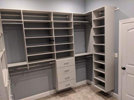 Grey and chrome closet with double hanging clothes, adjustable shelves and drawers.