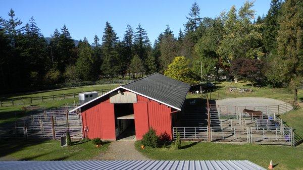 Stable with runs, photographed from roof of 60 X 160 foot enclosed all weather, lighted arena.