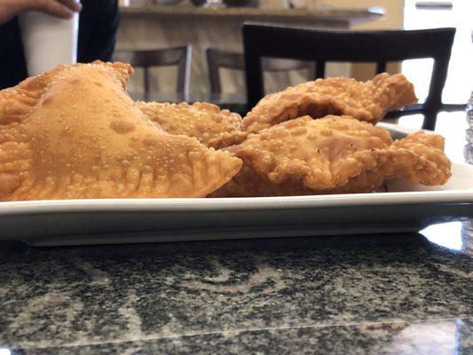 Closeup of freshly baked cheese empanadas. Treat yourself today and stop on by! (7/2/2018)