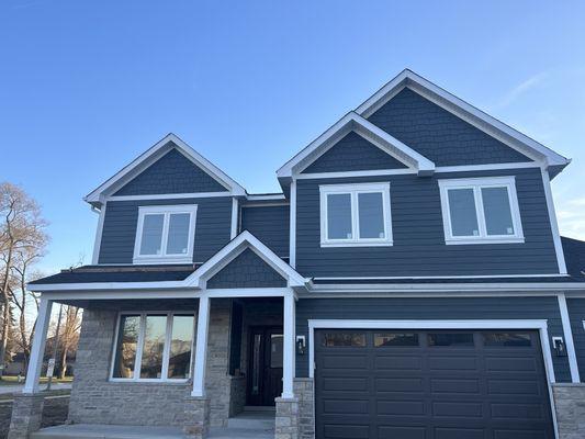 Roofing and siding installation on a new construction build.