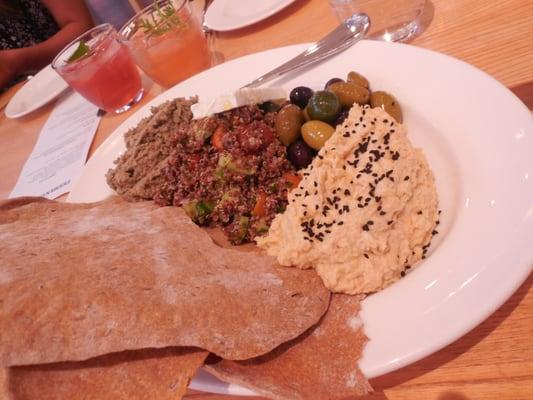 Two kinds of hummus, red quinoa salad and assorted olives with flat breads.  Healthy & tasty!