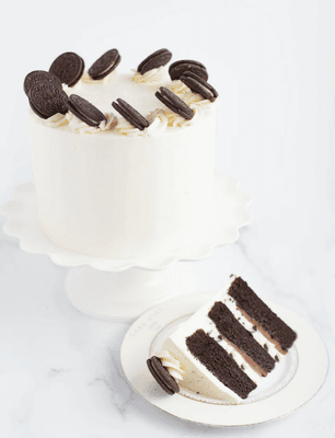 Our Cookies & Cream Cake is three layers of Valrhona French chocolate cake.