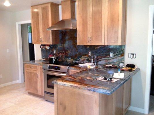 Incredible Brazilian granite surrounded by warm chestnut cabinetry