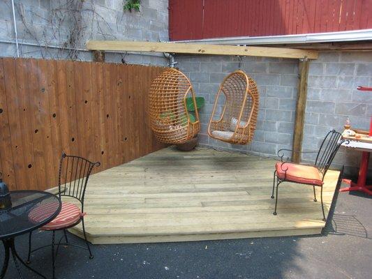 Downhouse Lounge, Brooklyn, NY. Floating chairs with supports and decking.