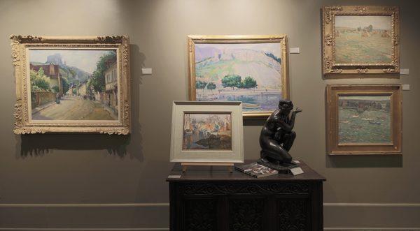 Paintings and a statue within the gallery space.