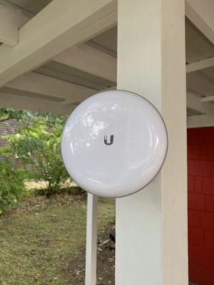 Ubiquiti Building-to-Building Bridge to wirelessly send high speed internet to a detached office.