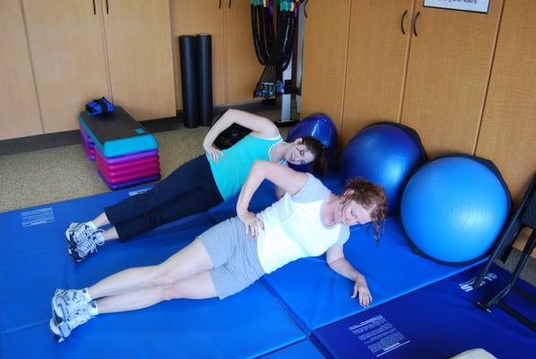 Clients working on their side planks to gain core strength