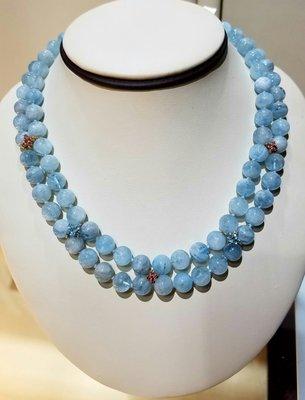 Hand beaded aquamarine necklace with yellow gold accents that are set with pink and blue topaz