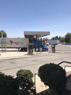 Photo from inside gas station. the dump station is right in between the two fields pumps...  near white signs...  close to ground.