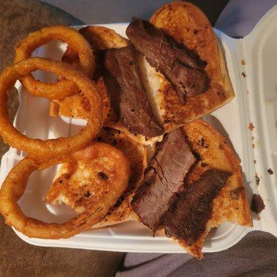 Sliced steak sandwich - dried out burnt steak - one onion ring and a piece of steak missing - inedible ($12.25)