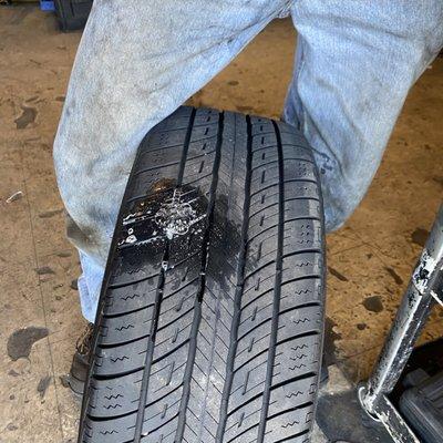 My tire being repaired by an employee.