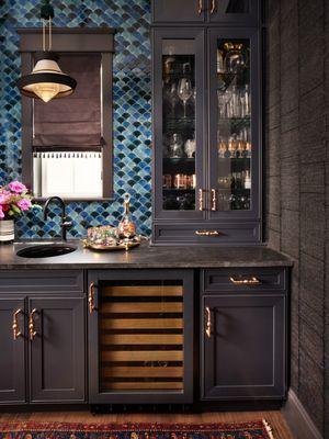 Charcoal painted solid wood cabinetry and blue glass mosaic backsplash make up this ever so gorgeous wet bar.  Recycled linen walls.