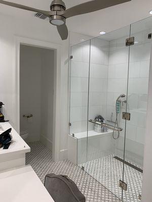 Frameless shower enclosure with 3/8" clear glass.