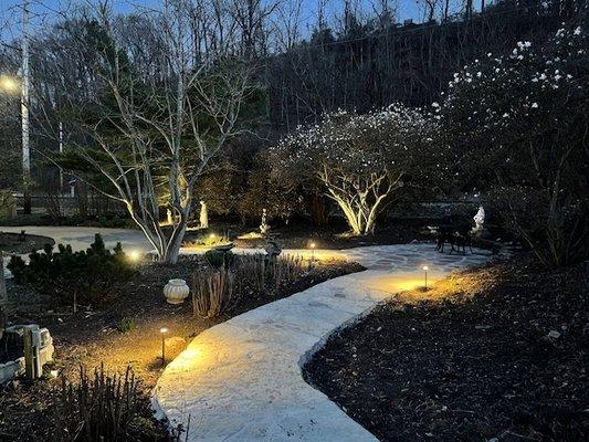 A new walkway accented by landscape lighting adds beauty, value and night time lighting to your yard.