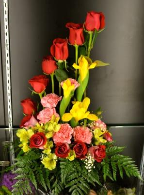 Floral arrangments with a 12 dz of roses, carnations,iris, million star and green leaves..