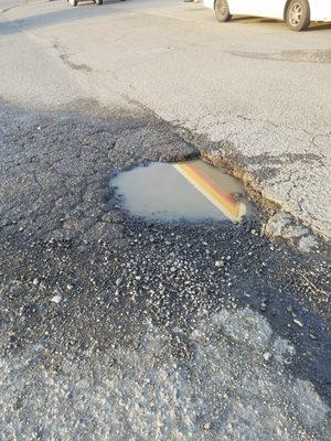 Huge pothole in their drive.