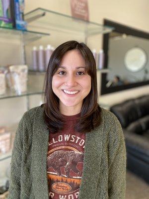 We cut 9 inches off of her hair and gave her a curtain fringe and a lot of razored layers