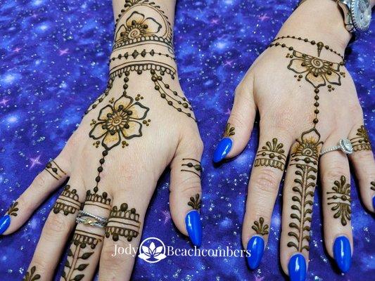 Lovely jewelry inspired henna designs on the hands.