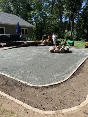 Path mix patio with boulders for a fire pit surrounded by edgers for a mulch garden