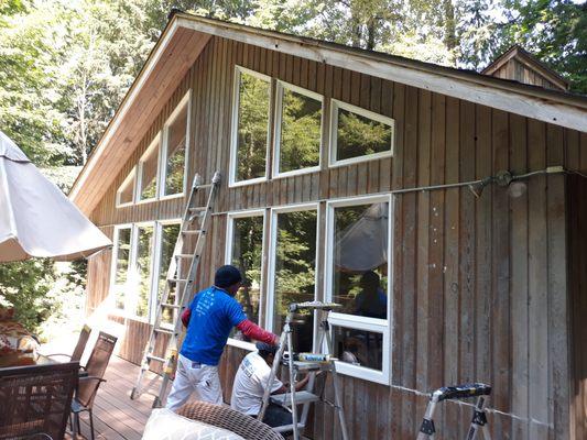 S&A Crew working on caulking and resealing the windows before staining it.