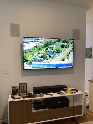 Tv mounting and home theater setup with in wall speakers.