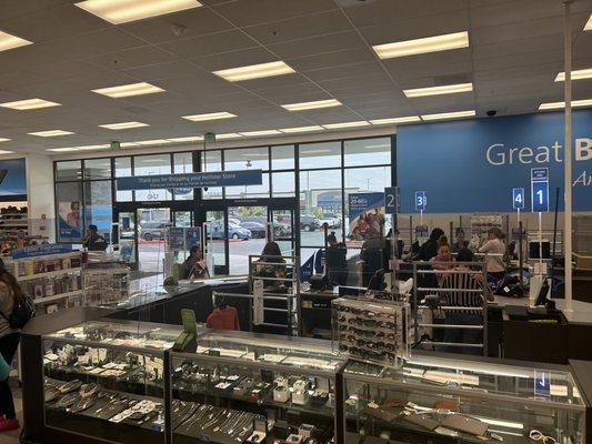 Jewelry counter. The employee running the returns   can help you. Note: The does slow down the returns line. But hey, they have to sell!