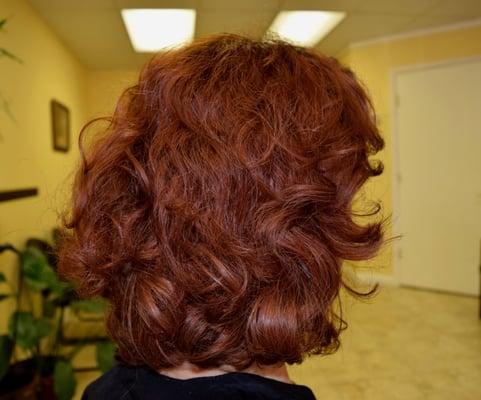 A great layered cut and fun red color enhances her beautiful waves.