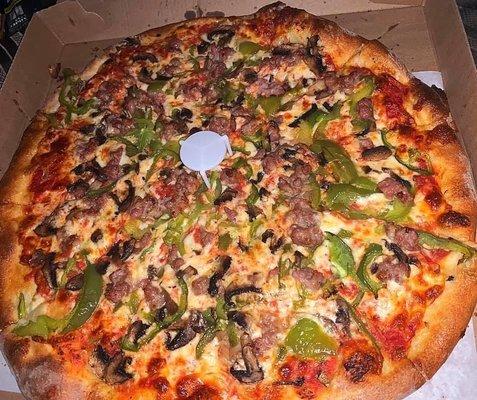 Pizza with mushrooms, sausage, and green peppers.