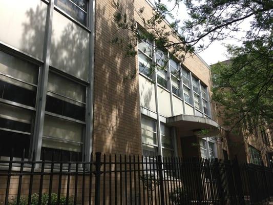 Back of the school, closest entrance to the principle's office.