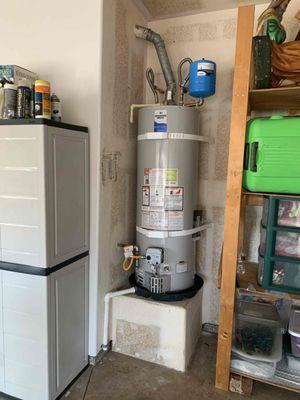 Gas tank water heater installation in garage