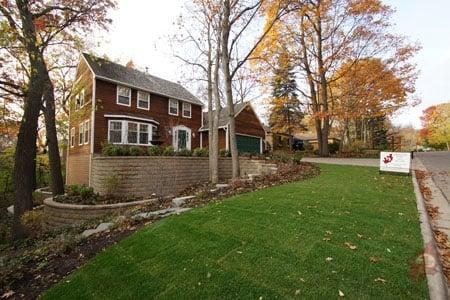 A Bloomington landscaping design that brought curb appeal to this once hidden home.  Retaining walls, driveways, and patios.