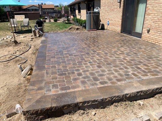 Short retaining wall capped, paver patio inside