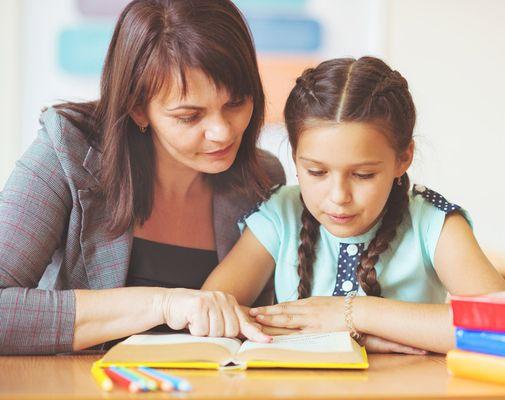 student receiving one-to-one instruction from teacher