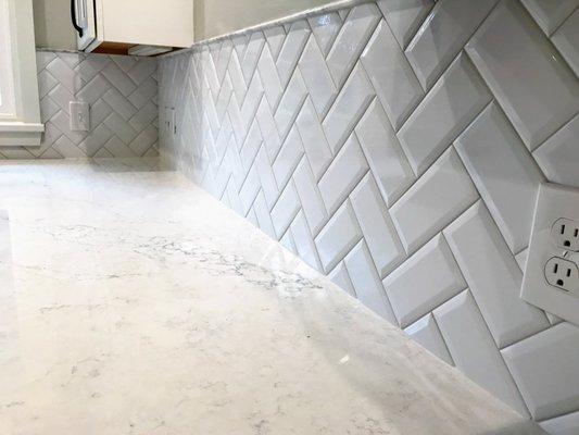 Herringbone white subway tile backsplash