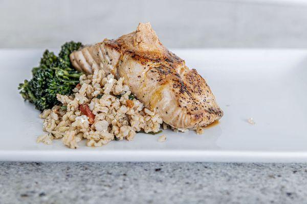 Seared salmon with sundried tomato butter over rice & broccoli