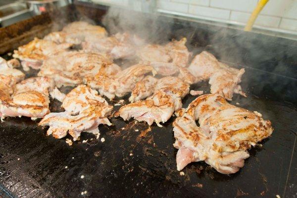 Sizzling chicken on the grill.