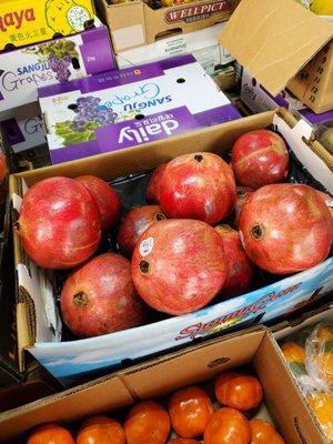 Fresh giant pomegranates grown locally and concord grapes from Korea