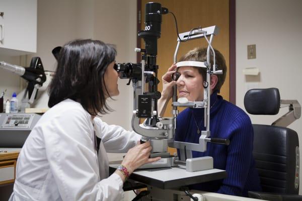 Dr. Deborah Schlossman, Ophthalmologist in the Beetham Eye Institute, giving a patient her eye exam