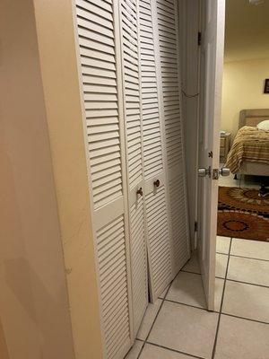 Hall closet with door hanging off and wires protruding from wall. Atlantic Charm.