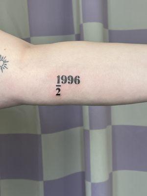 Fine line numerical tattoo