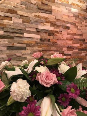 Floral arrangement with the main chapel stone backdrop