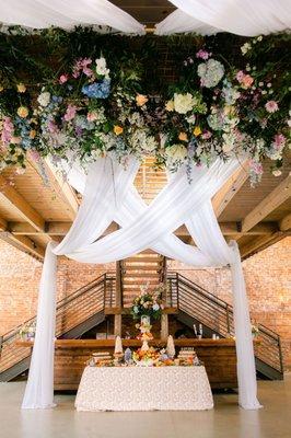 Hanging floral, drapes and grazing table