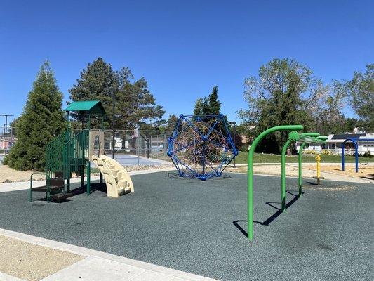 Other part of the playground with a metal zip line.