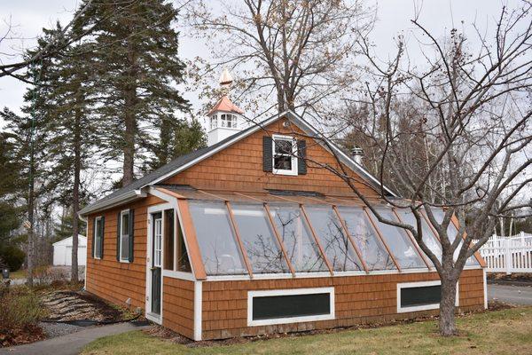 Our garage and greenhouse in Maine with its new decoration.