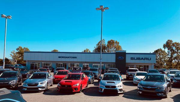 front of building with cars for sale