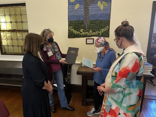 New members joining the congregation by signing the membership book (during COVID).