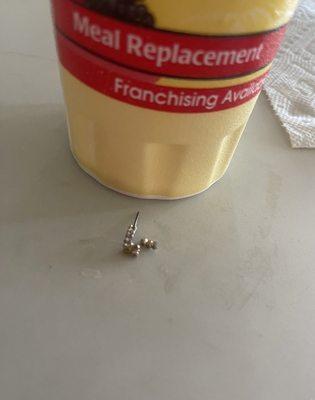 Earring next to the cup it was in