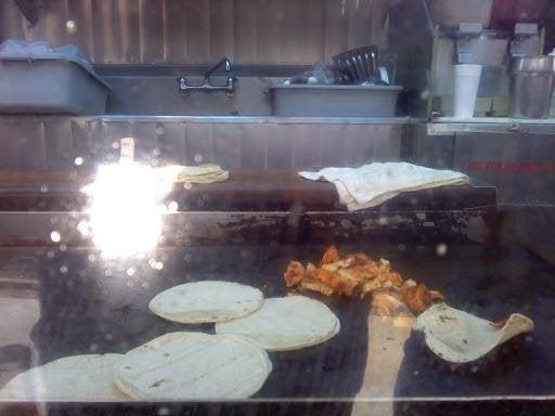 Chicken on the grill and this father and two children work hard