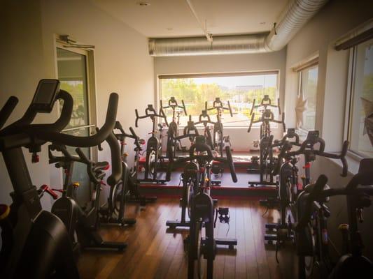 The room has 3 beautiful windows with 13 Cycling Bodycraft bikes, equipped with surround sound audio system.